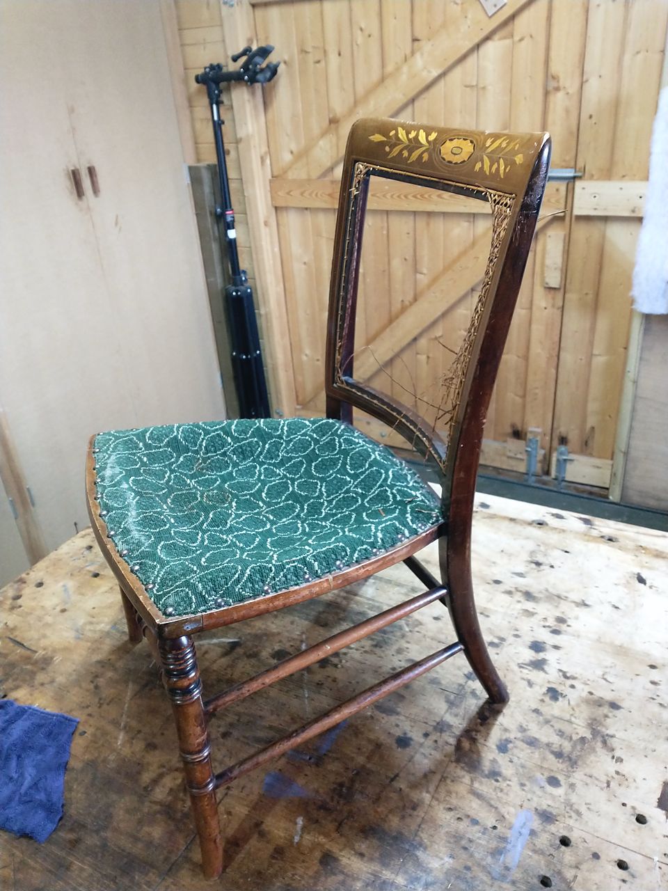 Inlaid bedroom chair before work: broken cane back and worn green upholstered seat